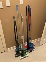 Group of all floor cleaning tools leaned against wall