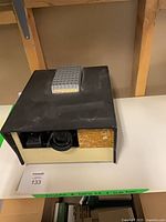 Front view of projector with lens and tray slot