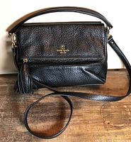 Full view of black Kate Spade purse with strap and tassel