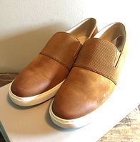 Top view of both loafers showing tan uppers and elastic band
