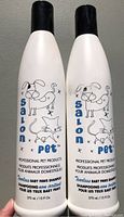 Front view of the two shampoo bottles showing brand, graphics and size
