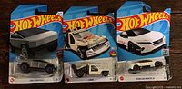 Front view of three sealed Hot Wheels cards showing Tesla Cybertruck, Lolux, Nissan Leaf NISMO RC_02