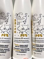 Front view of three Salon Pet conditioner bottles showing graphics and labeling