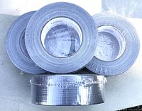 Four rolls of gray duct tape, shrink-wrapped