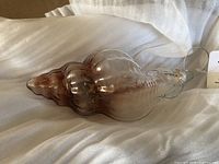 Full view of glass shell ornament on wrapping