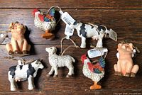 All seven farm animal ornaments grouped on tabletop
