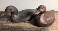 Both wooden ducks side by side