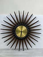 Full view of Syroco starburst wall clock showing all spokes and dial