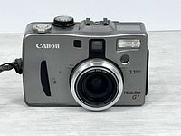 Front view of Canon PowerShot G1 showing lens, flash and branding