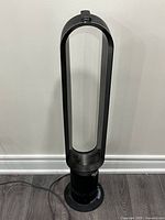 Full view of Dyson tower fan standing on floor
