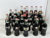 Group view of the full set of sealed Coca-Cola bottles