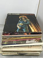 Stack of LPs topped by Neil Diamond Hot August Night
