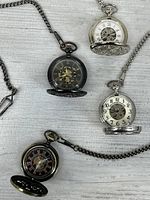 Group shot showing all four pocket watches and chains
