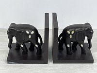 Front view of both elephant bookends showing design and condition