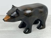 Profile view of carved wooden black bear