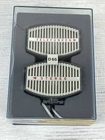 Microphone set in storage case, showing grille and branding