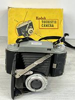 Front view of Kodak Tourist II camera extended with original box behind