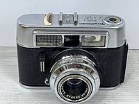 Front view showing lens, light meter window, and overall body condition