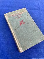 Worn green cloth hardcover field guide with taped spine