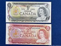 Front of both notes showing denominations, serial numbers, Queen Elizabeth II portrait.