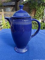 Left side view of royal blue Fiesta coffee pot with lid