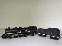 Side view of locomotive coupled to tender