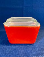 Side view of red Pyrex 501-B dish with lid attached