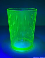 Tumbler glowing green under UV light
