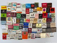 Full array of about 90 vintage matchbooks displayed on wall