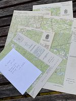 All six maps fanned on bench showing titles and scale data