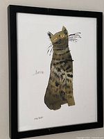 Frontal view of framed Andy Warhol “Sam” poster print