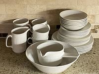 Full grouping of plates, mugs, pitchers and bowls