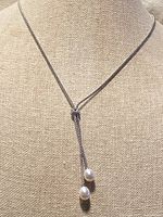 Full view of lariat necklace on display bust