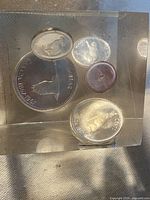 Top view of acrylic cube showing suspended 1967 Canadian coins