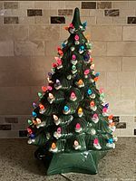 Front view of ceramic Christmas tree illuminated