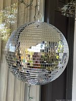 Full view of hanging mirror disco ball showing overall condition and reflective tiles