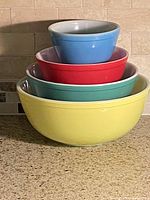Stacked view of all four colored bowls nested