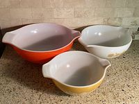 Three Pyrex bowls side by side showing interior and color