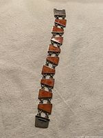 Full view of bracelet laid flat showing geometric links and clasp