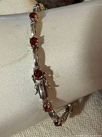 Full bracelet view showing overall design and garnet stones