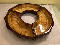 Three curved dishes assembled into complete ring showing overall form and glaze