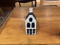 Front view showing windows, door and chimney