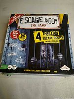 Front of Escape Room The Game box highlighting 4 scenarios and chrono decoder