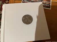 Reverse of 1945 Canadian Victory nickel showing torch, V and date