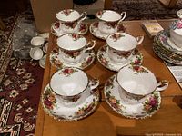 Set of six Royal Albert Old Country Roses teacups with saucers displayed on a table