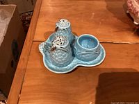 Full view of Wade Golden Turquoise condiment set on wooden surface