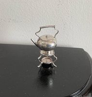 Full view of assembled miniature sterling teapot on stand