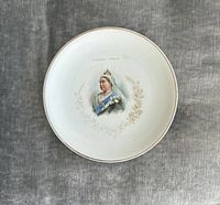 Full view of commemorative plate showing portrait, gilt rim, overall crazing