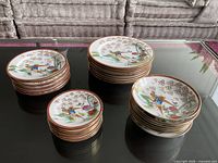 Stacked dinner, salad, bread plates and bowls showing quantity and pattern