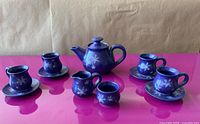 Front view of full 12-piece mini tea set showing all components and snowflake design